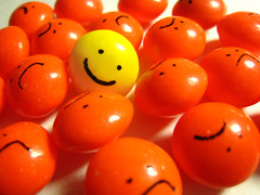 A yellow smiley face is in the middle of orange balls.